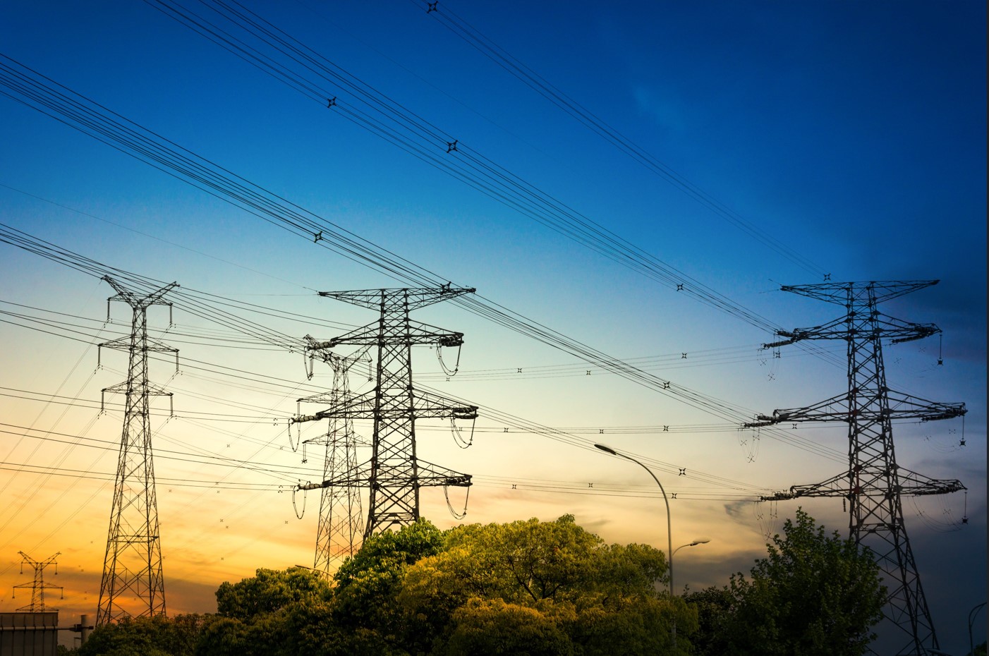 sun-setting-silhouette-electricity-pylons-min